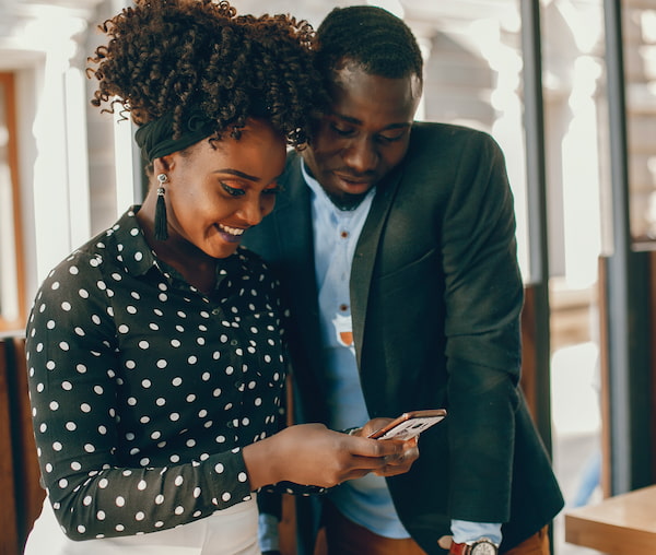 Man and woman looking at a phone