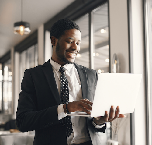 Man working on a computer smiling