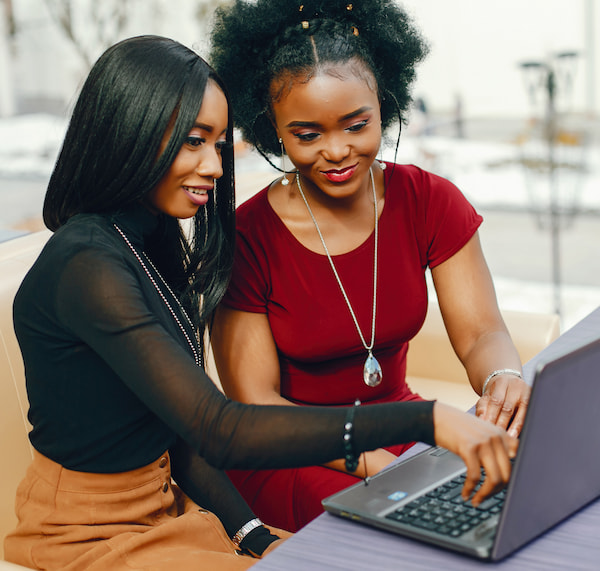 Two women looking at a computer