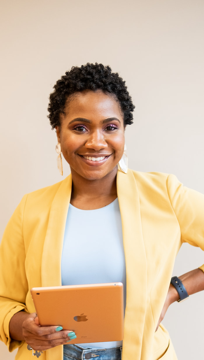 Woman holding and ipad and smiling